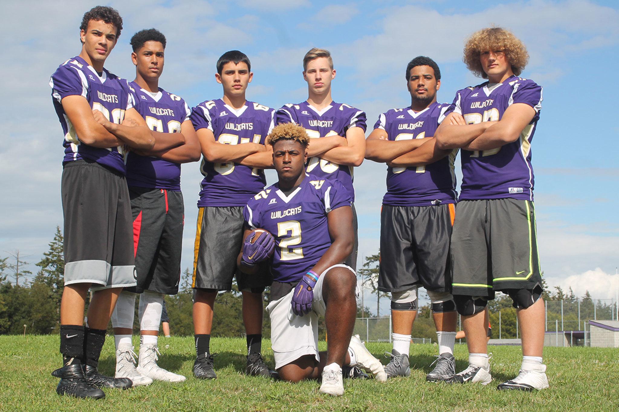 Princeton Lollar, front, is surrounded by the linemen who helped him set a new Oak Harbor High School career rushing record. From the left are Ozell Malcolm Jackson IV, Kamren Mebane, Weston Whitefoot, Colton Burdick, D&rsquo;Andre Bellamy and Sam Zook.