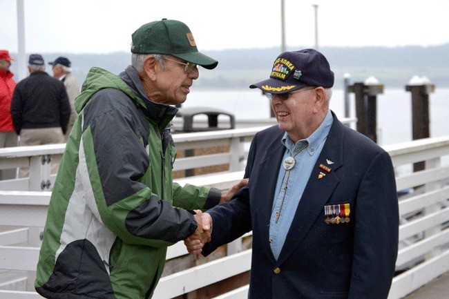 Left: Emmet Jaime shakes hands with Battle of Midway survivor Harry Ferrier