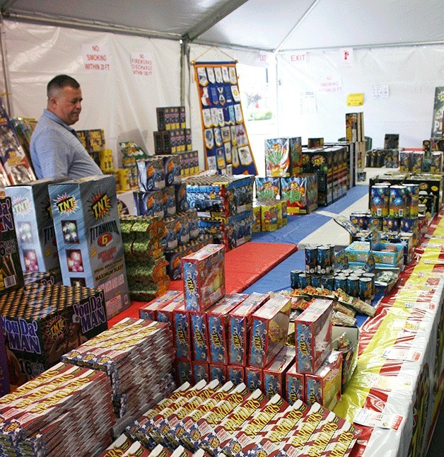 James Michaelangelo of Coupeville shops for fireworks at the Oak Harbor Rotary Club stand Monday at the Rite Aid lot.