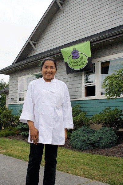 June Blouin proudly stands outside of her new business