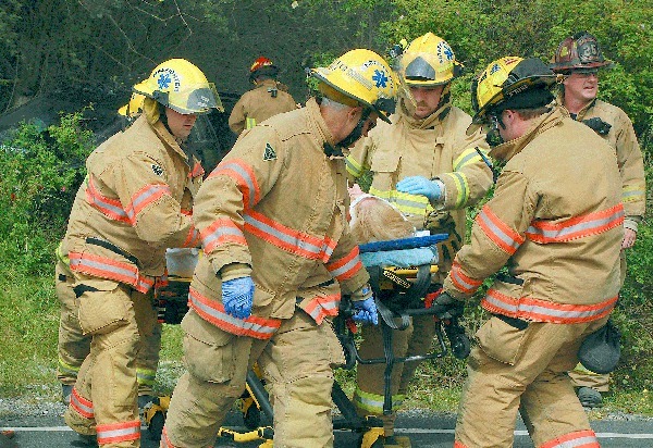 North Whidbey Fire and Rescue firefighters secure an Oak Harbor woman for transport to Whidbey General Hospital Friday