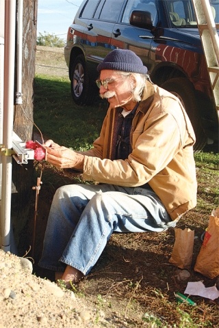 Volunteer Tom Vorhees works on the antenna used to broadcast KWPA