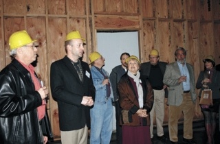 Contractor Ed Gemkow and marketing director Jason Dittmer give a media tour of the enlarged facility Friday night. The crowd is standing in the new rehearsal hall.