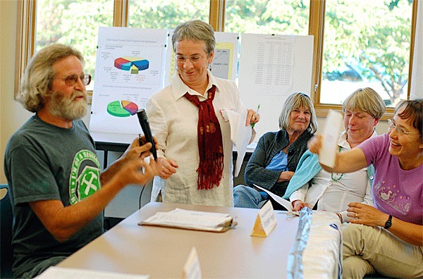 Coupeville resident Gary Wray answers a question while League of Women Voters President Mendy McLean-Stone attempts to enforce a response time limit at Monday’s forum in Coupeville on Island County’s proposed property tax hike.