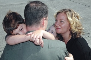 Writer Alison Buckholtz and children Ethan and Esther reunite with Scott after a deployment. She shares her life as a Navy wife in “Standing By.”