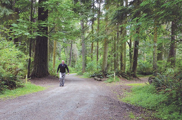 Freeland resident Keith Anderson walks through empty campgrounds at South Whidbey State Park Tuesday. The grounds