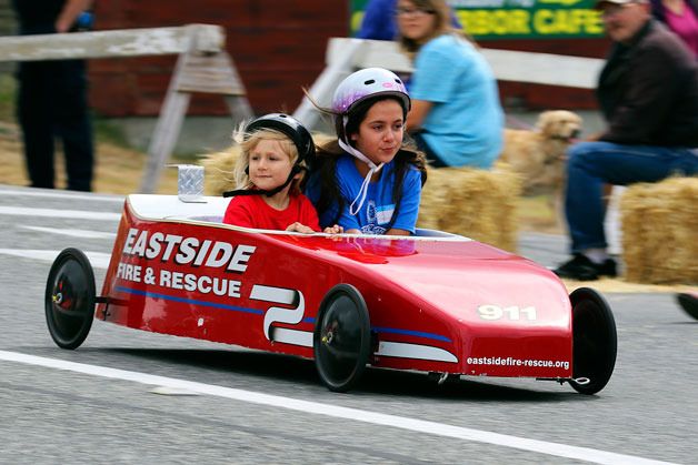 A pair of youngsters enjoy a ride down Barrington Avenue during the Rotary’s Challenge Series Gravity Races Saturday. Several dozen took part in the event which has been part of Oak Harbor summers for more than 25 years . See story on page A12.