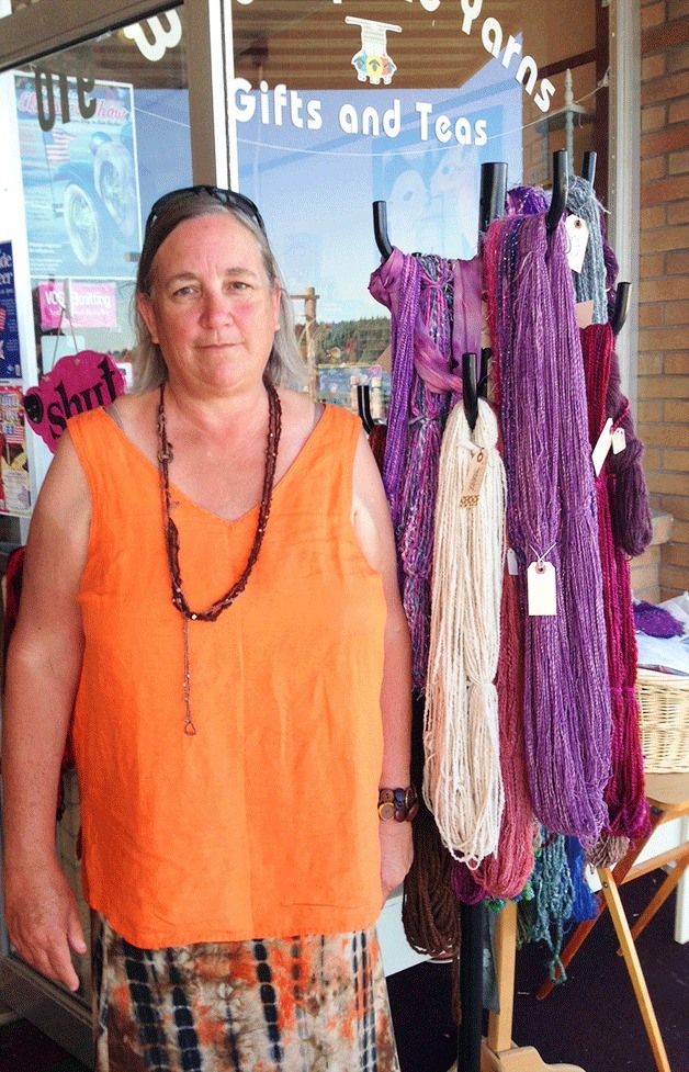 Business owner Dena Royal stands outside her Pioneer Way shop
