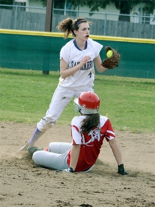 Oak Harbor shortstop Kaylee Meders puts the tag on Stanwood’s Jordan Nemo at second base for the third out in the top of the fourth inning.