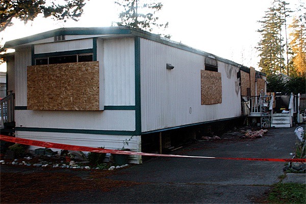 Windows are boarded up and red tape cordons off a mobile home in Parkwood Manor that was essentially destroyed by a fire Nov. 4.