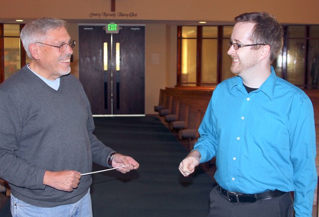 Darren McCoy (right) and Chet Hansen share a light moment at Oak Harbor’s First United Methodist Church Wednesday. McCoy will take over for Hansen as director of the Whidbey Community Chorus beginning in the fall.