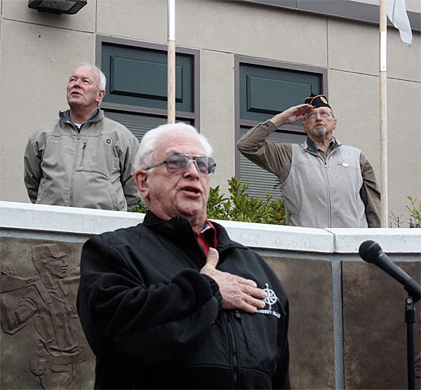 Coupeville Lions Club member David Barville leads people in singing the “Star Spangled Banner.”