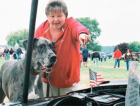 The North Whidbey Car Show Saturday was popular with woman and beast. Vicki Harvey of Langley and her faithful dog Geezer study the impressive engine of a 1977 Chevy SS owned by Bob Johnson. While the 190-pound Geezer appreciates a good engine