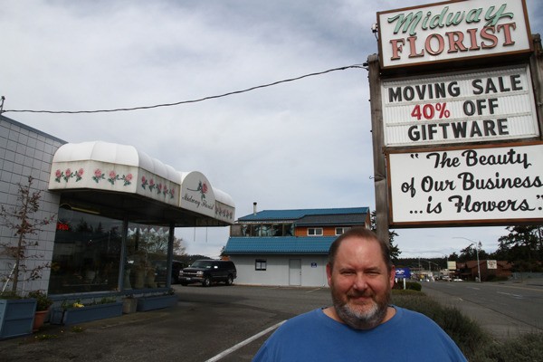 Midway Florist owner Rob McGowen poses under the business’s original sign