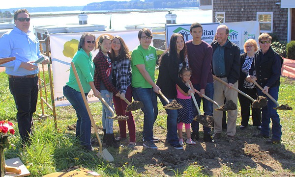 Organizers and the future homeowners of a Habitat for Humanity photo break ground on the site. Brett D’Antonio