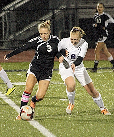 Oak Harbor's Suzanne Kaltenbach (8) tussles with Lynnwood's Dani Hayes for control of the ball. Kaltenbach scored the Wildcats' goal in the 1-1 tie.