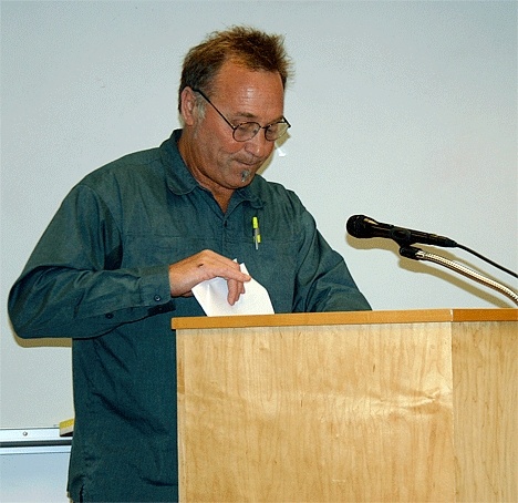 Coupeville resident Ken Pickard shuffles papers while speaking at a public hearing Tuesday evening in front of the town council.