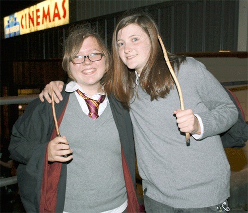 Mallory Hunt and Sarah Richards show the wands they brought to the opening of the latest Harry Potter film Thursday evening at Oak Harbor Cinemas.