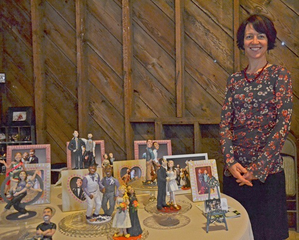 Valerie Heggenes presents her cake toppers during the Weddings on Whidbey and Events Tour on Saturday
