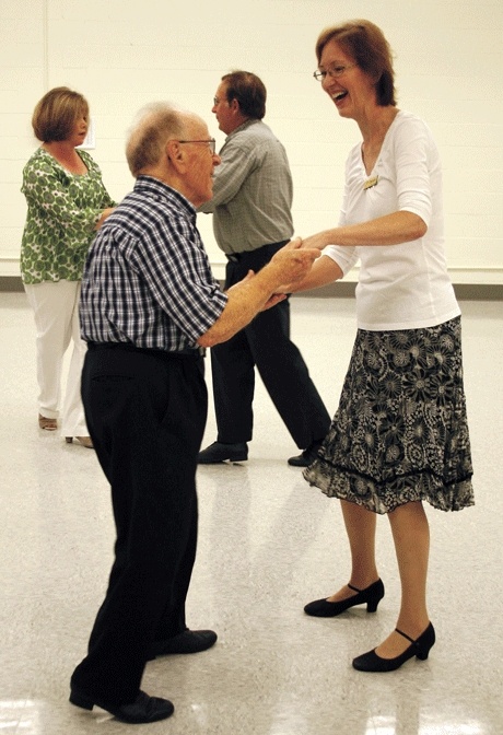 Assistant instructor Kathleen Mack partners with an attendee at the studio’s first social dance night