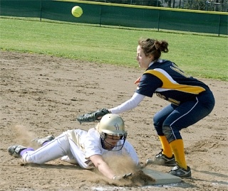 Whitney Osborn dives safely back into first base ahead of a pickoff attempt.