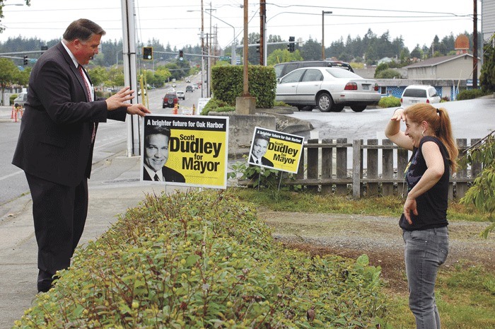 Oak Harbor mayoral candidate Scott Dudley asks D.J. Stinson to remove two of his campaign signs from her yard. Dudley was told last week by a city enforcement officer to remove his signs because they violate a city ordinance. But it turns out the city rule may be unconstitutional.
