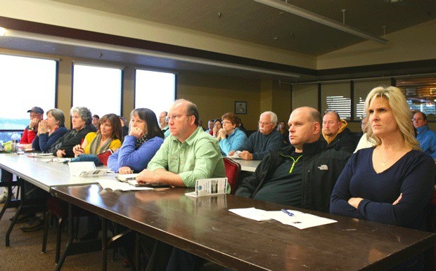 A room with nearly 60 retirees criticized Capt. Edward Simmer for policy changes made at Oak Harbor Naval Hospital.