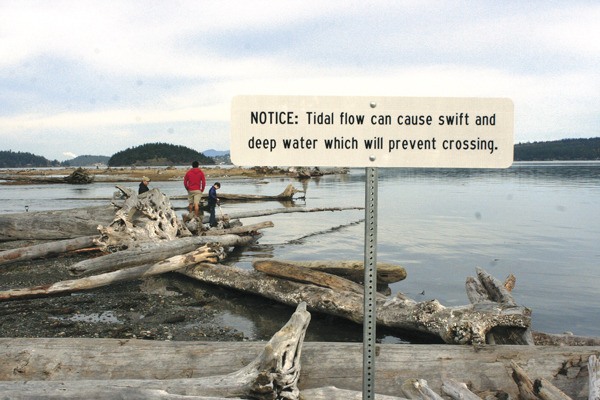 A warning sign greets people exploring popular Ala Spit last year. Ala Spit County Park will be closed Aug. 24 through Sept. 25 as a bulkhead is removed to restore salmon spawning areas.