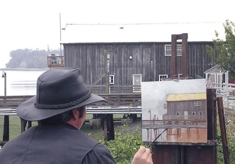 A plein air artist paints from the Coupeville Wharf at last year’s competition.