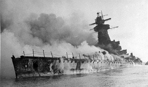 The German pocket battleship Graf Spee is scuttled by its captain in Montevideo Harbor. He saved his men from almost certain death