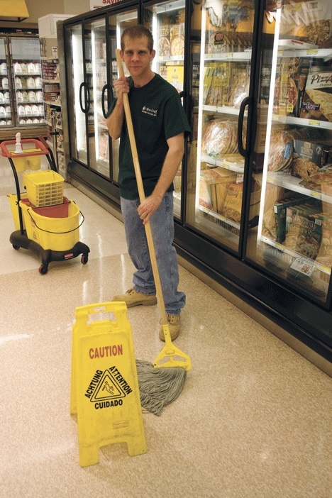 New Leaf Employee James Hollett mops the Commissary floor.