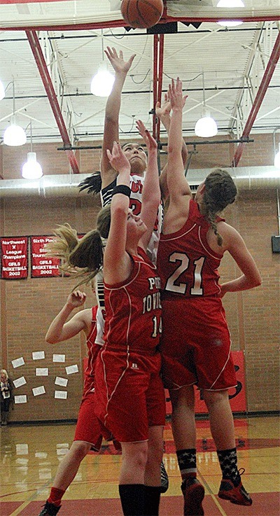 Makana Stone scores two of her 19 points over the defense of Port Townsend's Jenna Carson (14) and Shenoa Snyder (21).