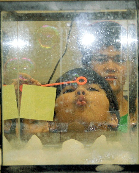 Tre Camacho tests a science experiment in the chemistry lab