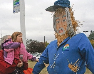 A Coupeville kid named Ariel admires a scarecow on the lawn of the Whidbey General Hospital.
