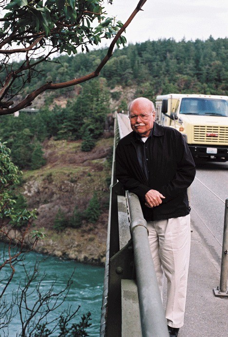 Author Richard F. Haines leans against the Deception Pass Bridge
