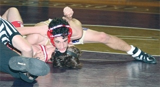 Oak Harbor’s John Tuttle works a pinning combination on Mountlake Terrace wrestler Zach Leonard in the152-pound bout. The senior didn’t get the pin