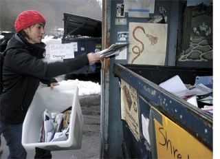 Langley resident Mackenzie Neal dumps paper in the bin at Island Recycling. The Freeland-based recycler continues to collect residents recyclables despite a dramatic decline in the value of such goods.