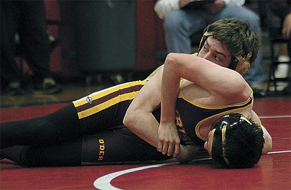 Oak Harbor's Christian Bertram peeks back to get advice from his coaches in a 16-1 win over O'Dea's Korry Broderick in the title match at 113 pounds.