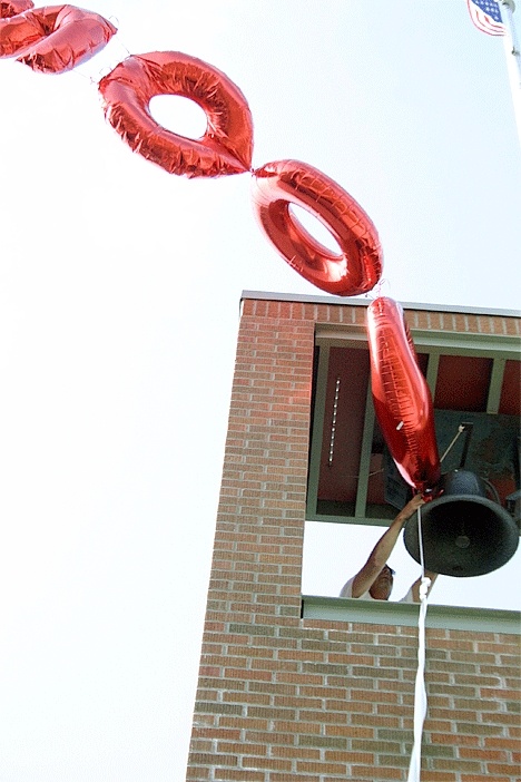 Coupeville High School maintenance worker Corey Cross cuts down a 2009 balloon Monday that pranksters tied to the school’s bell tower. That balloon was one of the decorations used in Friday evening’s graduation ceremony. Someone also toilet-papered several trees in front of the school.