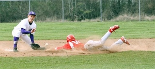Stanwood’s Chad Murdock slides head-first safely into second base just ahead of the throw to Oak Harbor second baseman Ryan Byrne.