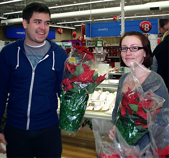 Oak Harbor residents Andrew and Ashleigh LaMaster take advantage of a 99-cent poinsettia sale during Black Friday events at Walmart on Nov. 26.