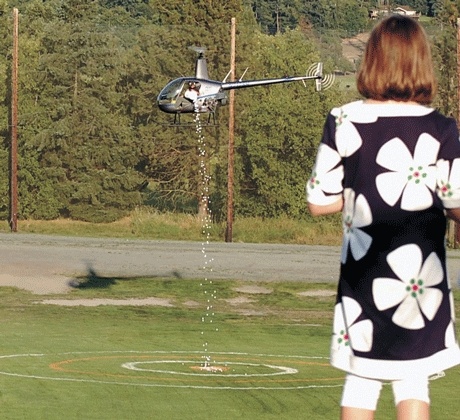 A girl looks on as the helicopter drops the 1