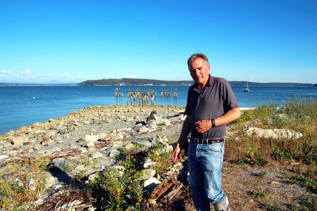 Greenbank resident Bruce Montgomery stands on beach property that is the subject of a lawsuit. The county claims that the property is public while Montgomery argues he owns it.