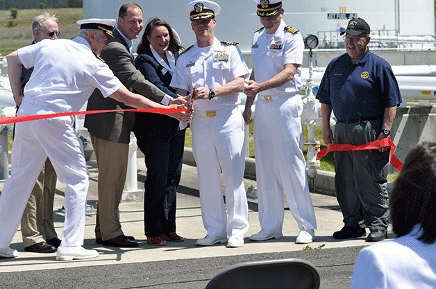 Assisting NAS Whidbey Island Commanding Officer Mike Nortier cut the ribbon for the base’s new fuel pipeline system are (left to right) Capt. William Power