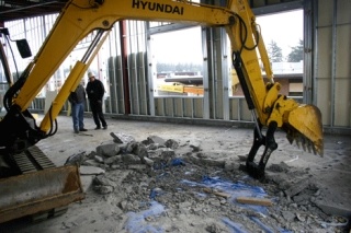 Removal of the concrete flooring began Tuesday as crews used a jackhammer in the southeast corner of the new Career and Technical Building at Oak Harbor High School.