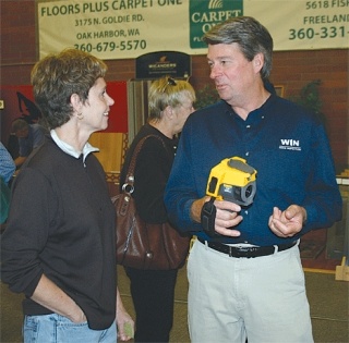 Bruce Klassen of WIN Home Inspection shows Coupeville resident Julie Roth how a thermal imaging camera works. His was one of the numerous Whidbey Island-based businesses that participated in the 17th annual Uniquely Whidbey Biz Expo held over the weekend in Coupeville.