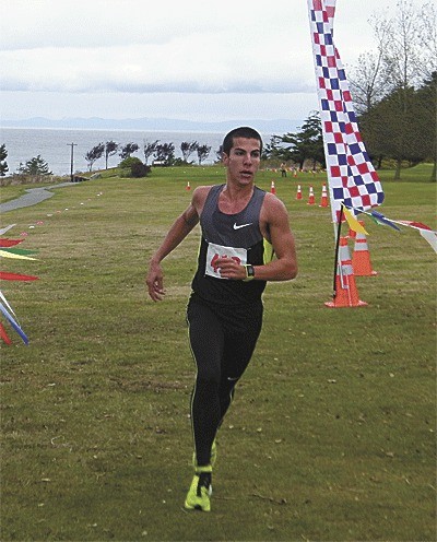 Olympian Donn Cabral nears the finish line in winning the Runnin' the Rock cross country meet 4K open division in record time.