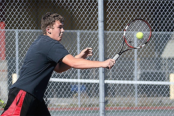 Joseph Wedekind smacks a backhand in Monday's match with Sequim.