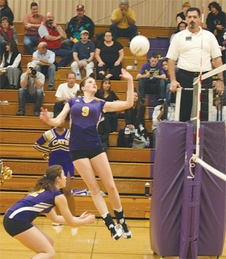 Oak Harbor’s Jessica Muzzall puts a little body English on the ball to score a point in Monday’s match against Cascade.