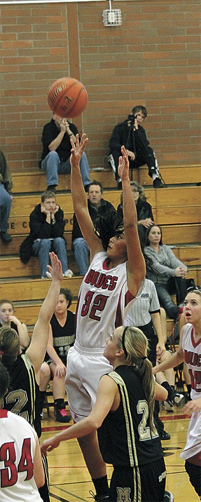 Coupeville's Makana Stone rises above the Meridian defense to hit a hoop in the Wolves' win Saturday.